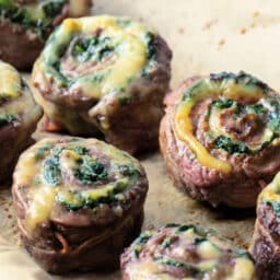 Individual flank steak pinwheels with spinach and havarti cheese.