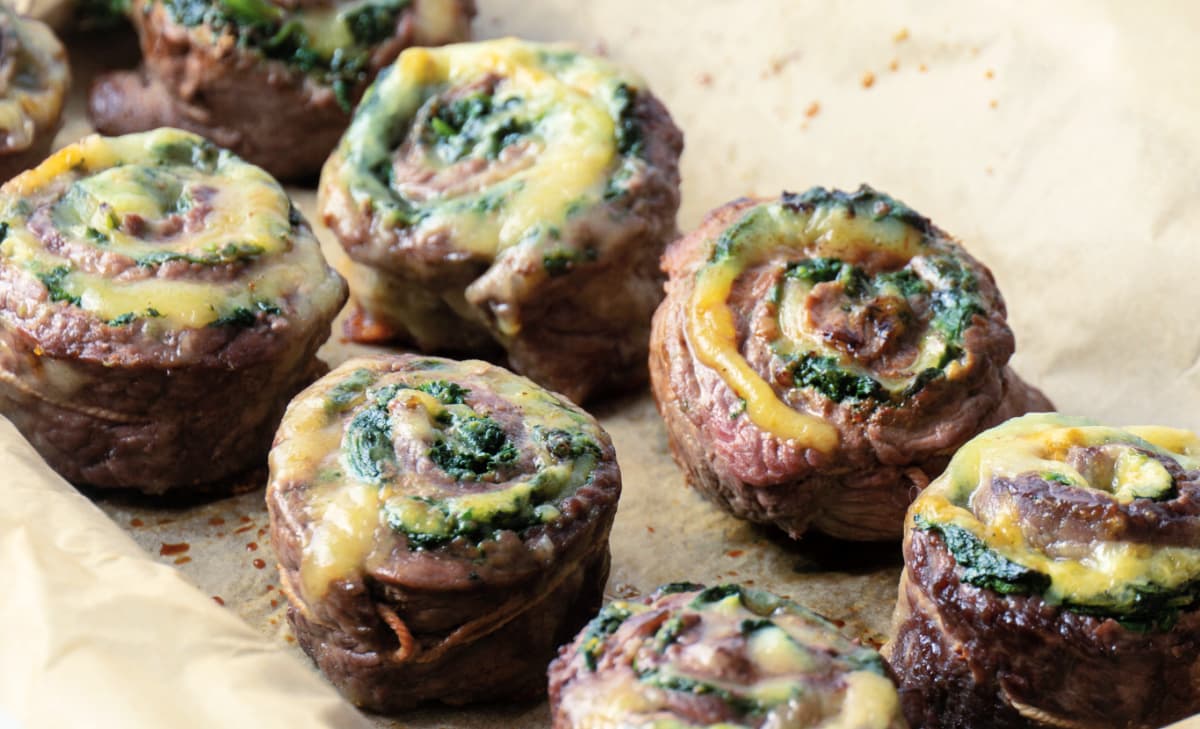 Individual flank steak pinwheels with spinach and havarti cheese.