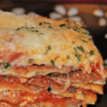 Eggplant Parmesan made with thin sliced, breaded and fried eggplant layered with marinara sauce and Mozzarella cheese.