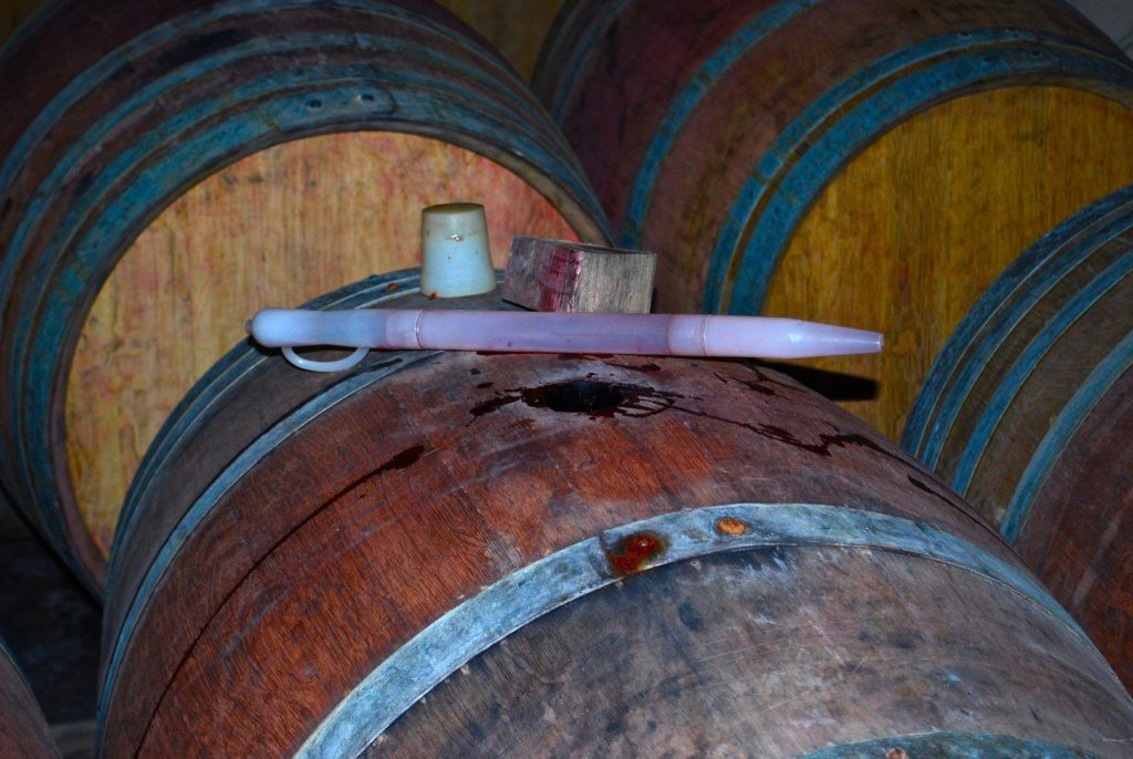 A close up of a barrel with wine