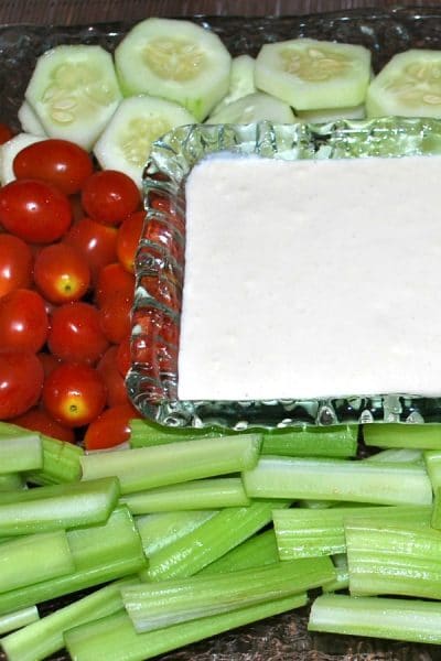 Garlic and Cheese Crudite Dip in a bowl in the middle of fresh vegetables.