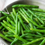 crispy sauteed green beans in a skillet