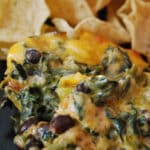 Fiesta Chicken Spinach Dip made with chili rubbed chicken, spinach, black beans, tomatoes and cheddar cheese makes a tasty game day snack.