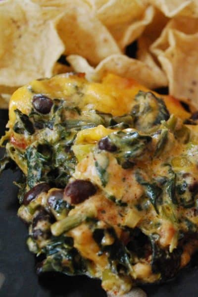 Fiesta Chicken Spinach Dip made with chili rubbed chicken, spinach, black beans, tomatoes and cheddar cheese makes a tasty game day snack.