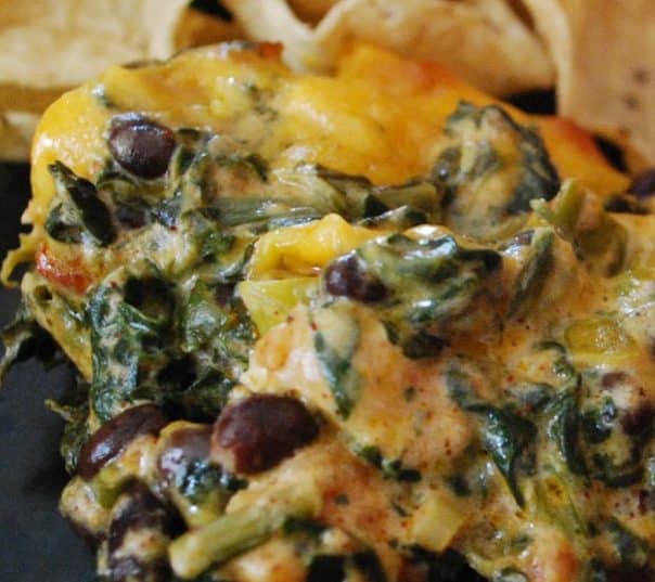 Fiesta Chicken Spinach Dip made with chili rubbed chicken, spinach, black beans, tomatoes and cheddar cheese makes a tasty game day snack.