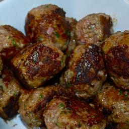 A plate of food, with Meatball
