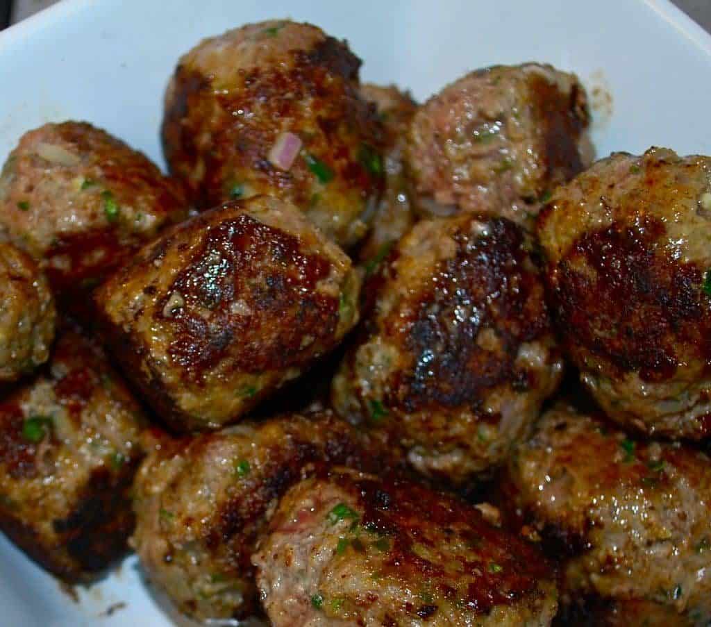 A plate of food, with Meatball