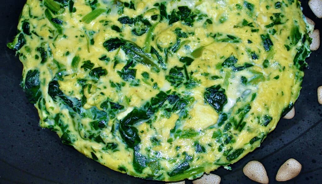 A close up of spinach havarti frittata