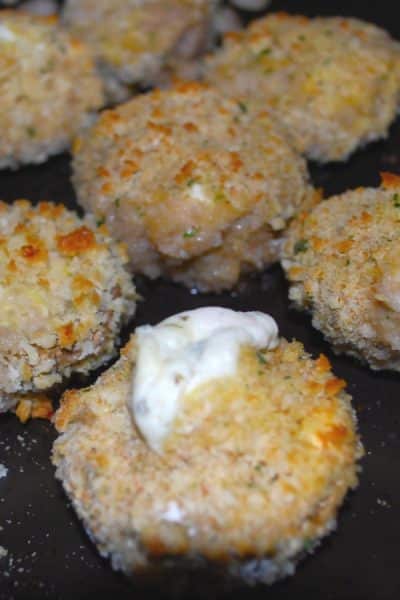 Mushrooms stuffed with garlic & herb spreadable cheese; then breaded and baked until the cheese is oozing from the center.
