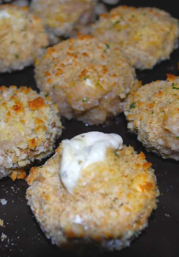 Mushrooms stuffed with garlic & herb spreadable cheese; then breaded and baked until the cheese is oozing from the center.