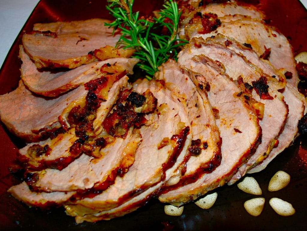 Horseradish, Garlic &amp; Rosemary Encrusted Roast Beef sliced on a plate. 