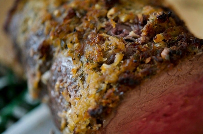 A close up the herb crust on top of cooked roast beef. 