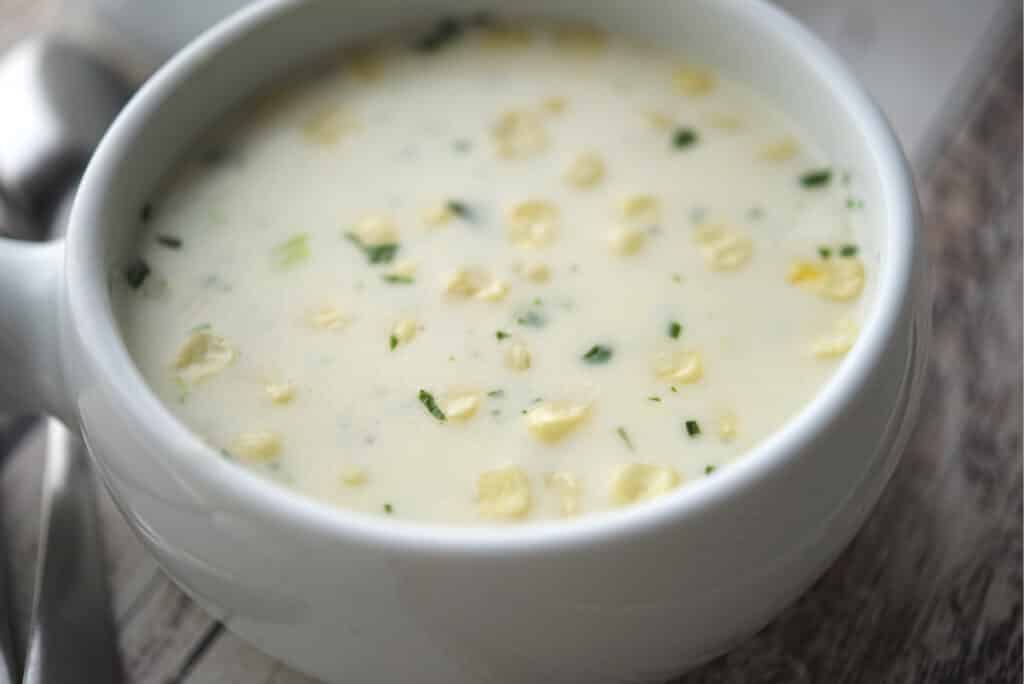 Basil Corn Chowder in white soup crock