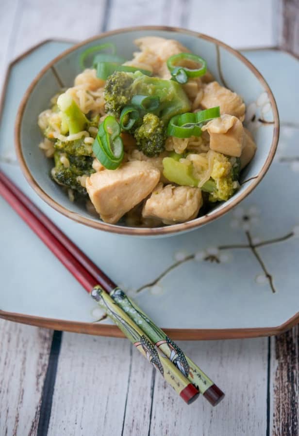 A bowl of Asian Chicken and Broccoli with chop sticks 