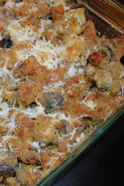 A close up sausage and roasted eggplant casserole in a dish.