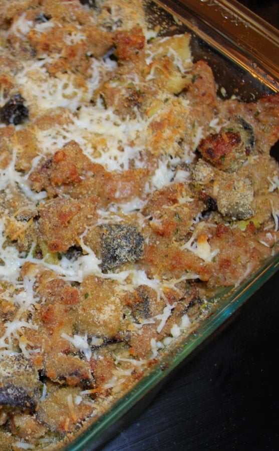 A close up sausage and roasted eggplant casserole in a dish. 