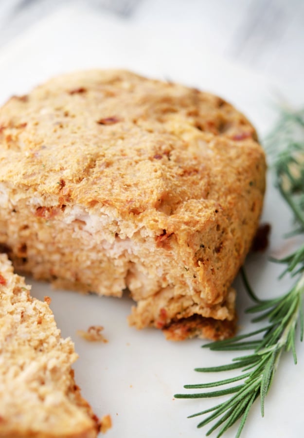 A close up of a piece of sun dried tomato turkey meatloaf on a plate