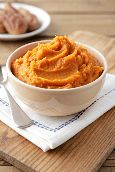 a white bowl with buttermilk mashed sweet potatoes
