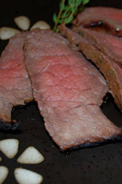 Grilled London broil steak marinated in balsamic vinegar, white wine, oil, garlic powder and fresh thyme is deliciously flavorful and tender. 