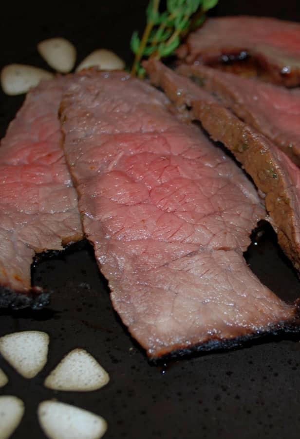 Grilled London broil steak marinated in balsamic vinegar, white wine, oil, garlic powder and fresh thyme is deliciously flavorful and tender. 