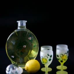Limoncello in a bottle with shot glasses
