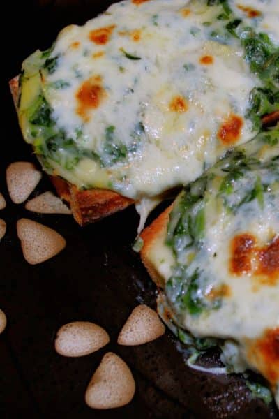 A close up of a Spinach Artichoke French Bread Pizza