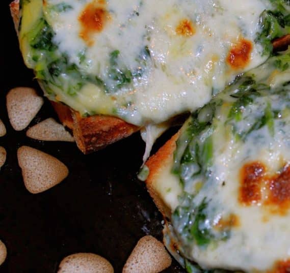 A close up of a Spinach Artichoke French Bread Pizza