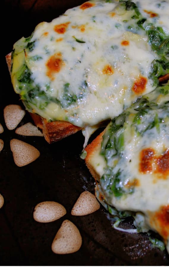 A close up of a Spinach Artichoke French Bread Pizza