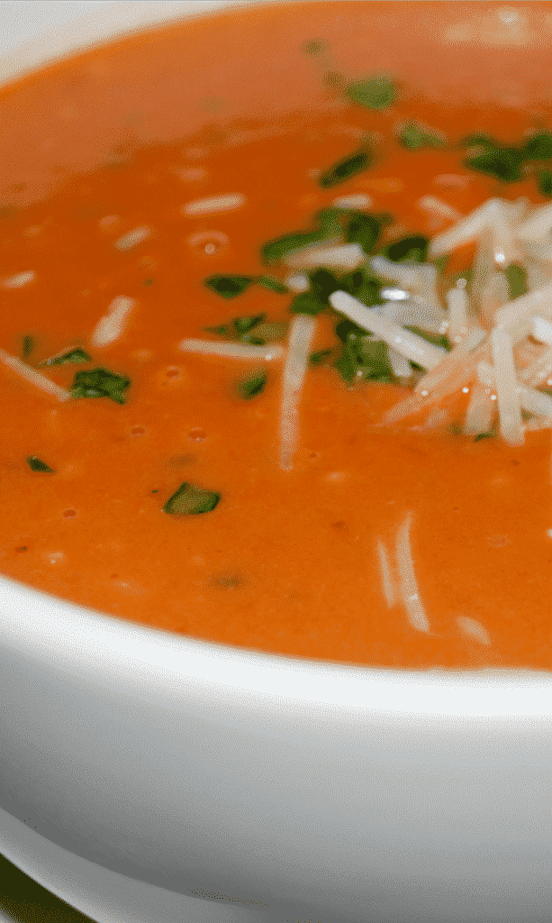 A bowl of soup, with Tomato and Basil