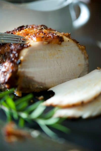 Center cut pork loin roast basted with a combination of maple syrup, prepared horseradish, Dijon mustard, garlic and fresh rosemary sliced.