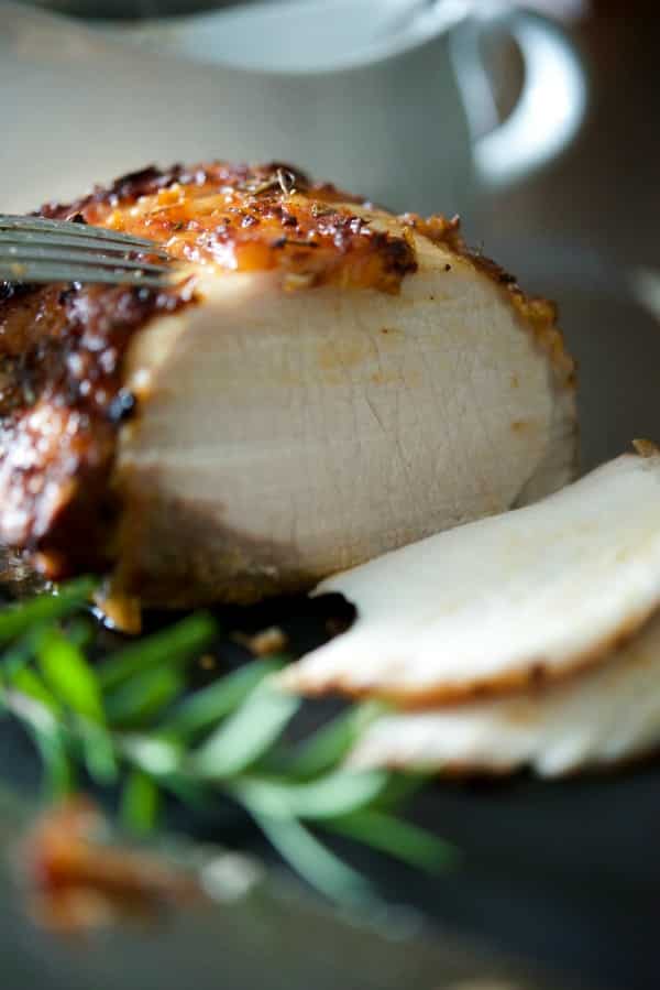 Center cut pork loin roast basted with a combination of maple syrup, prepared horseradish, Dijon mustard, garlic and fresh rosemary sliced. 
