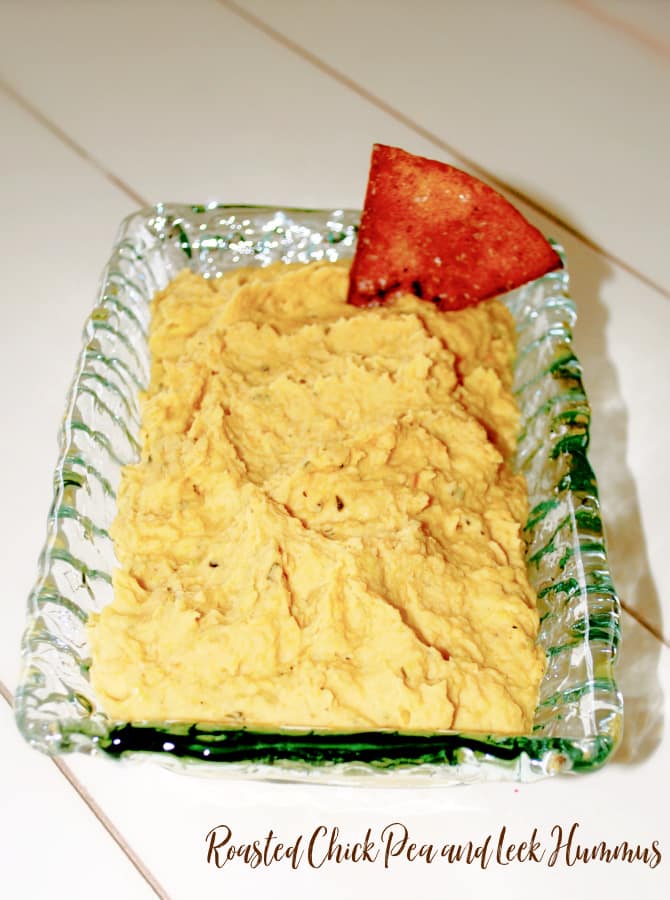 Roasted Chick Pea and Leek Hummus in a glass serving dish. 