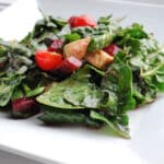 Spinach salad in a white plate.