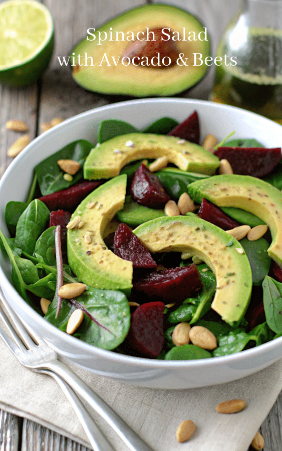 a bowl of spinach with avocado and beets 