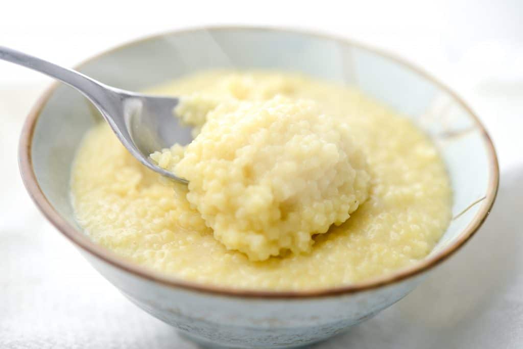 A bowl of pastina on a spoon. 