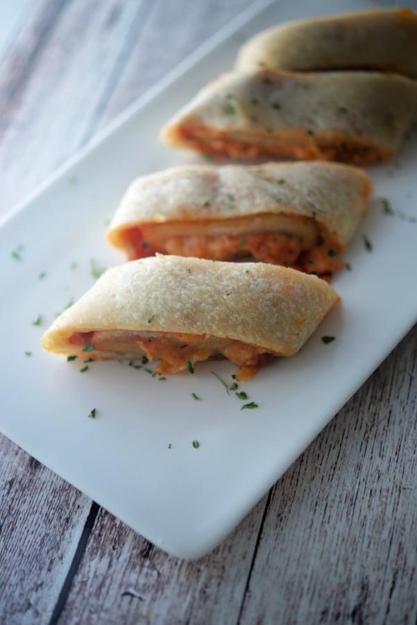 Pizza Roll Stromboli lined up on a white platter