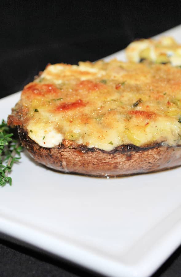 Three Cheese Zucchini Stuffed Portobello Mushrooms on a white serving dish