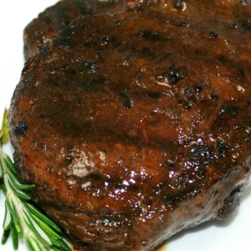 A close up of filet mignon on a plate.