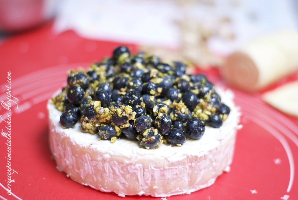 Fresh blueberries, chopped pistachios and honey top creamy Brie cheese
