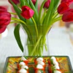 Cherry Tomatoes stuffed with pearl sized Mozzarella cheese and fresh basil.