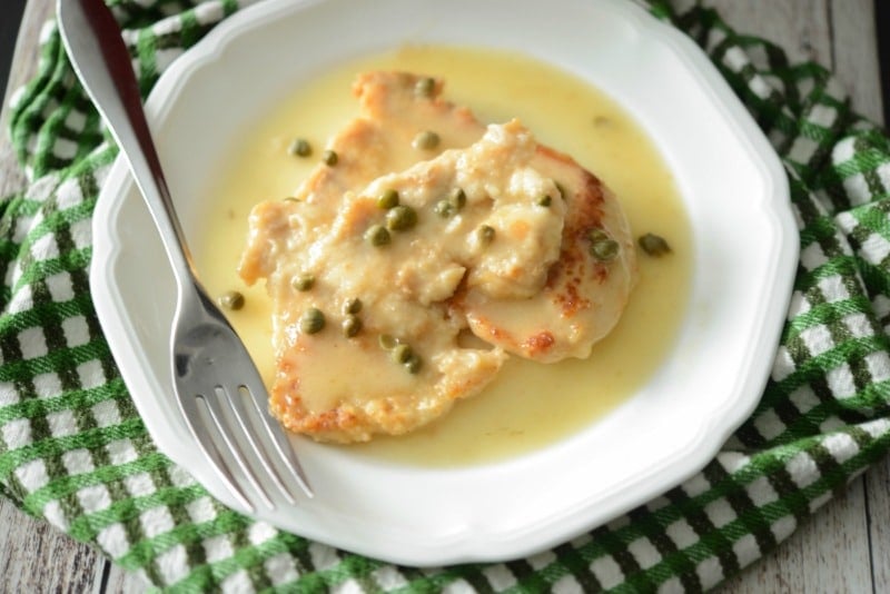 A plate of food with a fork, with Chicken and Piccata
