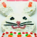 Easter Bunny Cake made with boxed carrot cake and homemade cream cheese icing; then decorated with your favorite candy.