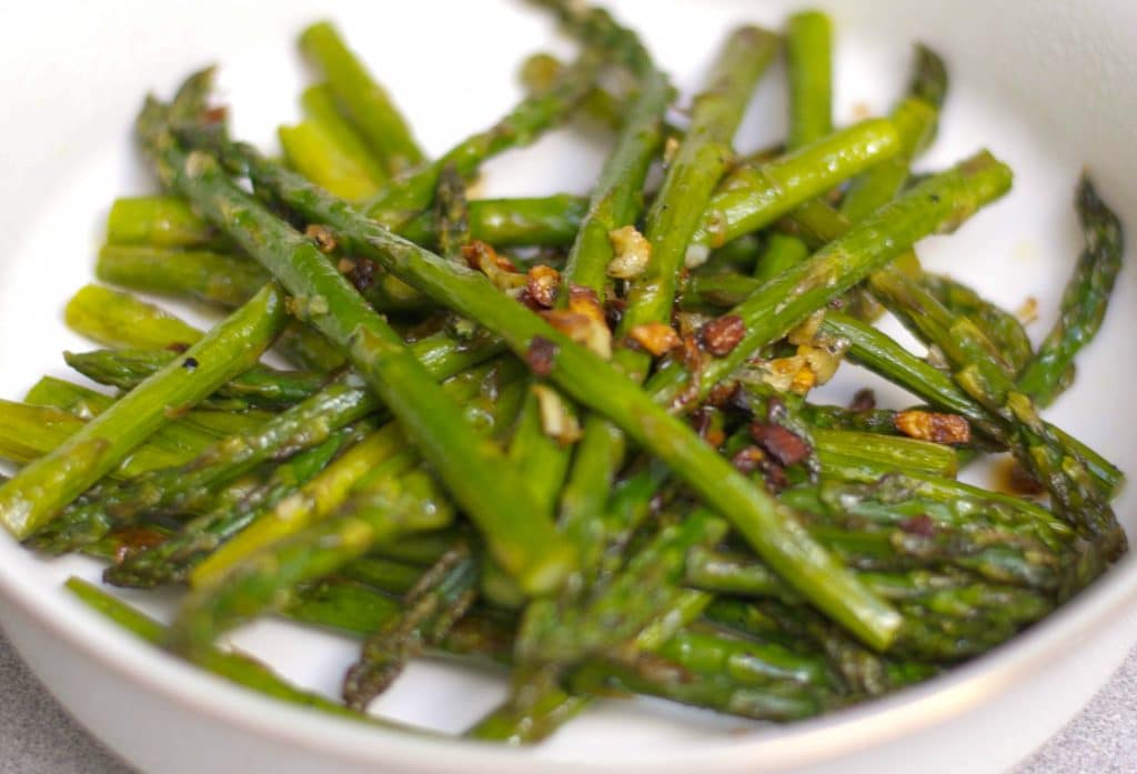 Fresh asparagus tossed with garlic, extra virgin olive oil, Kosher salt and fresh ground pepper; then roasted until caramelized. 