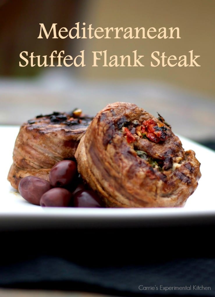 Flank steak stuffed with Kalamata olives, sun dried tomatoes, garlic, basil and feta cheese on a plate. 