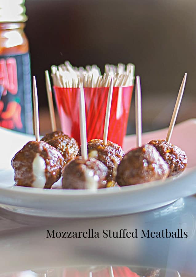 A close up of a plate of mini meatballs. 