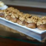 A plate of sausage stuffed mushrooms.