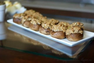A plate of sausage stuffed mushrooms.