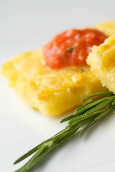 Italian Polenta made with yellow cornmeal, sea salt and fresh rosemary; then grilled and topped with a Roasted Roma Tomato Coulis.