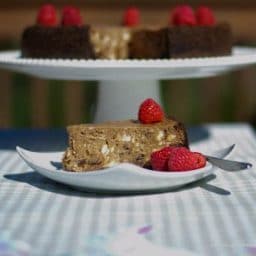 A piece of Triple Chocolate Raspberry Cheesecake sitting on top of a table