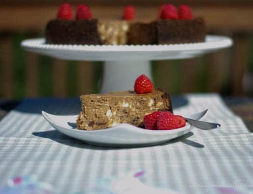 A piece of Triple Chocolate Raspberry Cheesecake sitting on top of a table